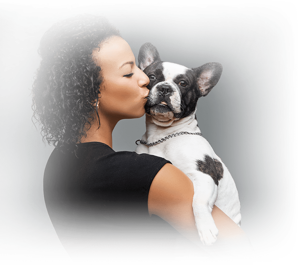Woman kissing her pet dog